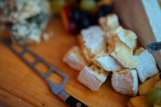 Soft brie cheese with crackers and nuts closeup