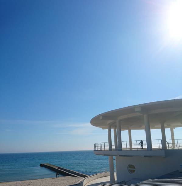 istock Spring walk to the ocean.  Bright sun, bright sky and blue waves. 1212161114