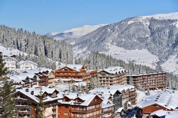 Ski resort in winter with snowy mountains Ski resort village with wood houses and snowy mountains courchevel stock pictures, royalty-free photos & images