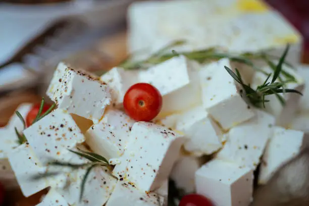 Feta cheese cut in cubes stock photo. Shadow DOF. Developed from RAW; retouched with special care and attention; Small amount of grain added for best final impression. 16 bit Adobe RGB color profile.