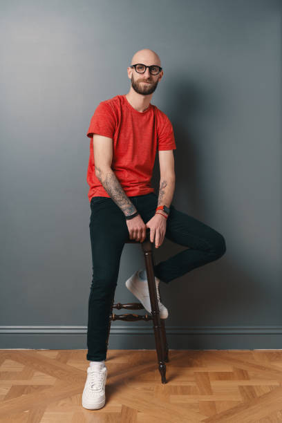 istock Stylish young man posing in the studio on gray background 1212161649