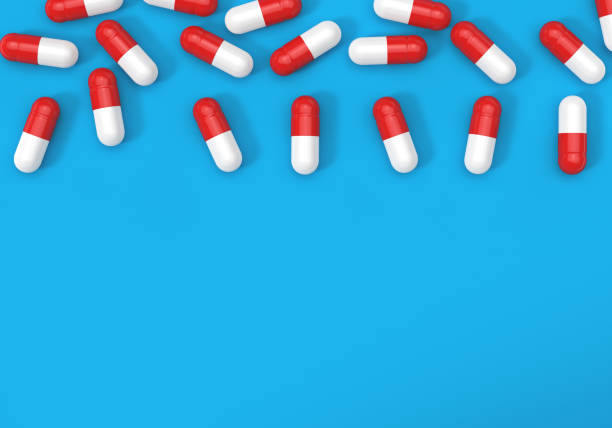 istock Top view of capsule pills on the blue background 1212163125