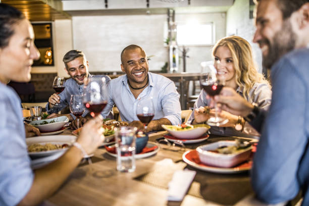istock Happy business colleagues communicating while enjoying in their lunch in a restaurant. 1212163523