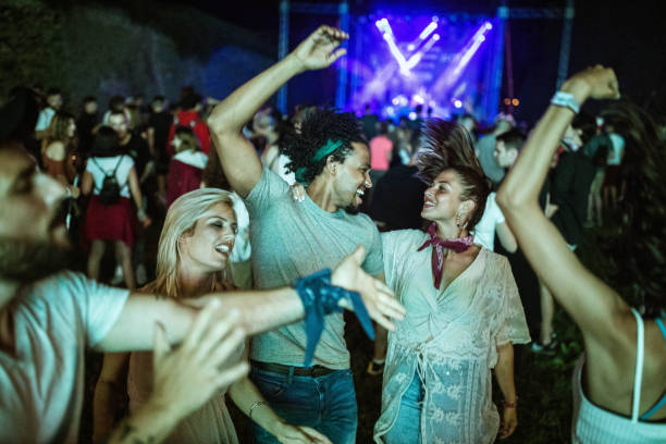 istock Happy couple disco dancing on a music concert. 1212164919