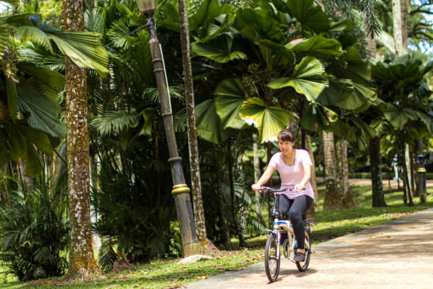 istock Lady cycling in the park 1212166253