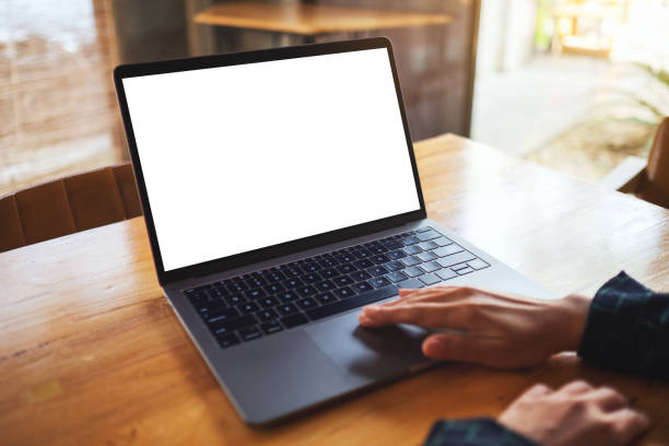 istock a woman using and touching on laptop computer touchpad with blank white desktop screen on wooden table 1212169334