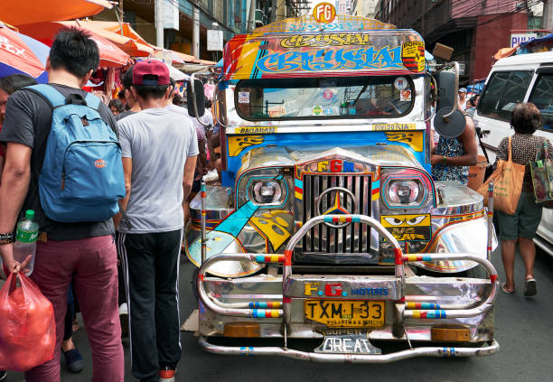Colorful Jeepney in busy Divisoria Market, Manila Divisoria Market, Manila, Philippines - December 3, 2016: Front view of colorful jeepney, traditional transportation, surrounded by busy shoppers divisoria market stock pictures, royalty-free photos & images