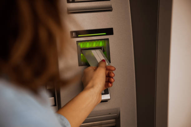 istock Woman using modern ATM nashine - cash withdrawal. 1212171554
