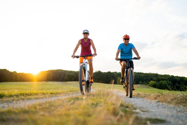istock happy couple enjoying mountain biking together 1212171605