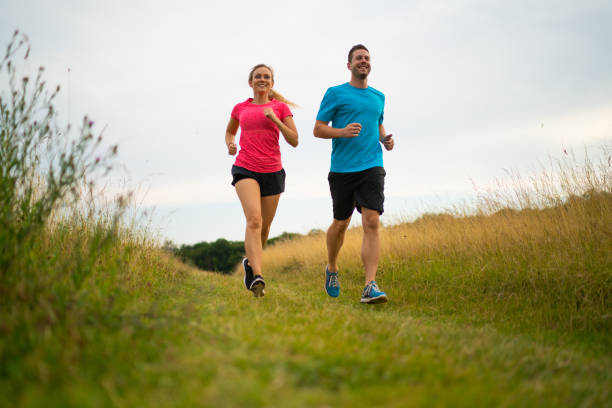 istock low perspective happy couple running over meadow 1212171639
