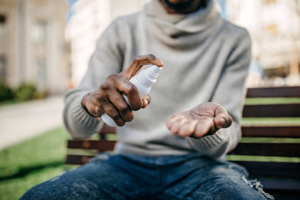 istock Young adult applying hand lotion 1212171862