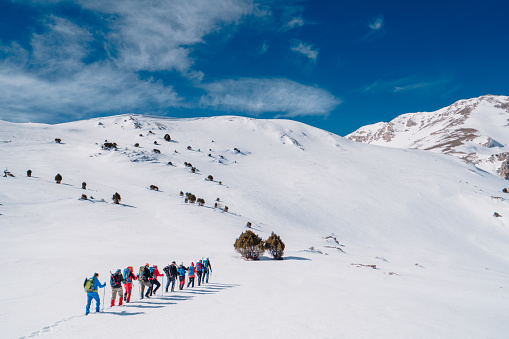 Climbers are walking to the summit of the high altitude mountains in winter time in Turkey ,recorded during a climbing expedition.