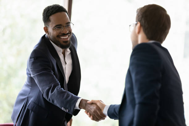 istock Diverse male colleagues handshake get acquainted at meeting 1212172509
