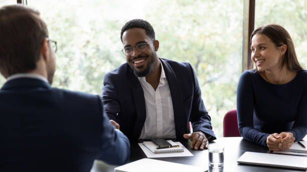 istock Smiling male colleagues shake hands get acquainted in office 1212172526
