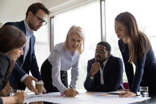 istock Multiracial businesspeople cooperate at office briefing together 1212172545