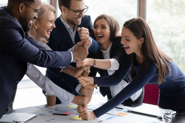istock Overjoyed diverse businesspeople engaged in teambuilding activity at meeting 1212172550