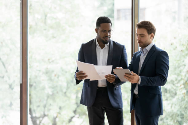 istock Diverse businessmen cooperate in office discussing project 1212172566