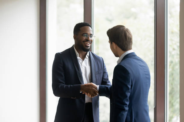 istock Overjoyed multiracial business partners shake hands after meeting 1212172568