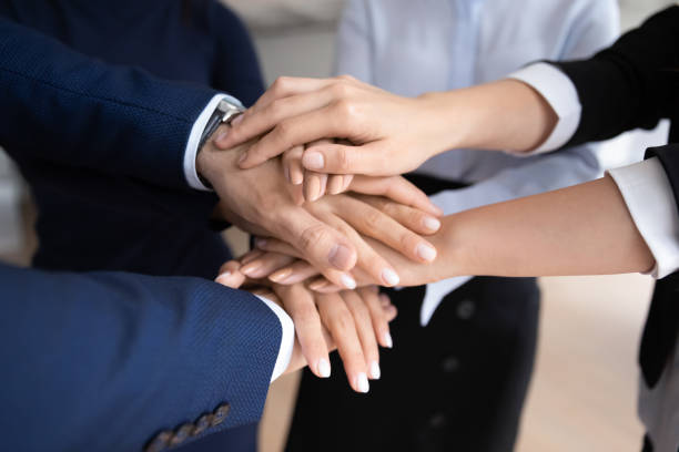 istock Diverse businesspeople engaged in teambuilding activity in office 1212172586
