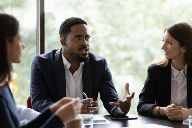 istock Diverse multiracial colleagues discuss ideas at briefing 1212172785