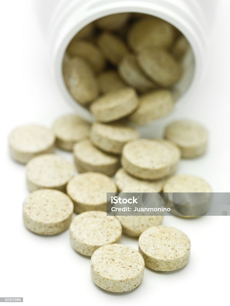 Uma pilha de pílulas cair de uma banheira em um fundo branco - Royalty-free Acessibilidade Foto de stock