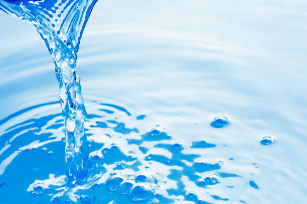 istock Clear blue water pouring into a pool 1212174059