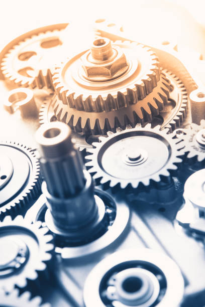 istock gears industrial background with warm shiny light 1212174829