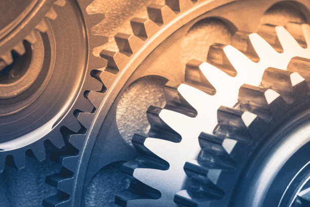 istock gears industrial background with warm shiny light 1212174836