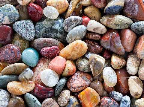 Focus Stacked Image of a Collection of Tumbled or Polished Stones to Include Agates, Petified Wood and Semi Precious Stones