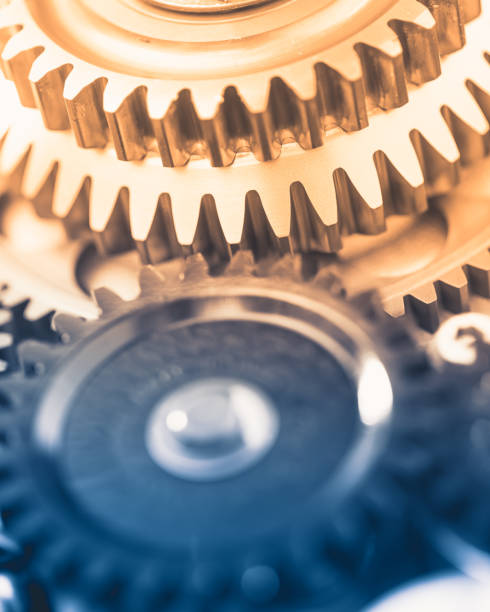 istock gears industrial background with warm shiny light 1212174855