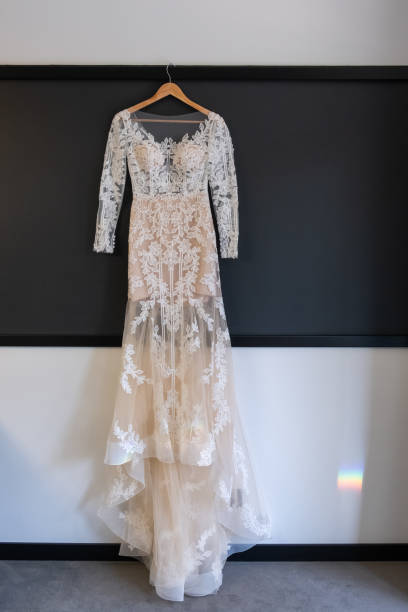 istock Wedding preparations - beautiful wedding dress on a custom hanger 1212175012