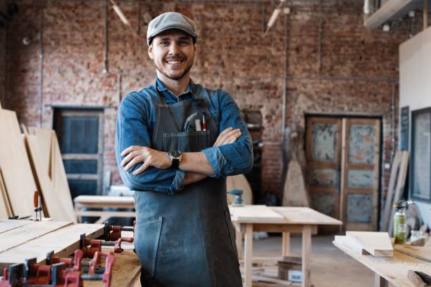 istock Successful handsome businessman with stylish cap work in carpentry 1212175172