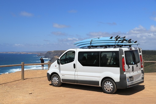 Surfer van Renault Trafic parked in Ferragudo. Coastal region of Algarve attracts more than 17 million tourists annually.