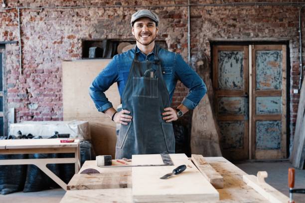 istock Successful handsome businessman with stylish cap work in carpentry 1212175431