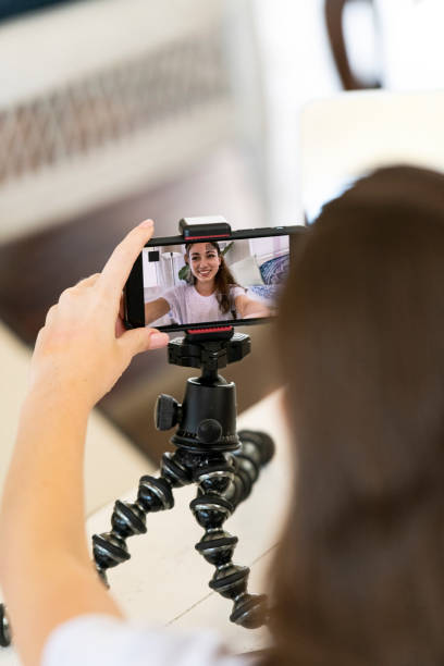 istock Video blogger checks her image in smart phone screen 1212179072