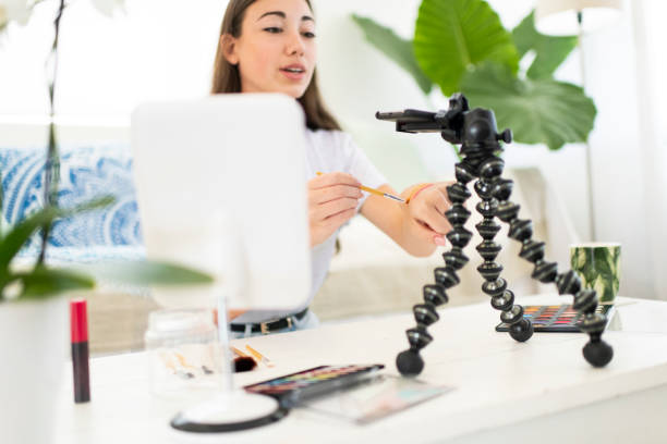 istock Beauty vlogger testing make-up on hand for smart phone camera 1212179210