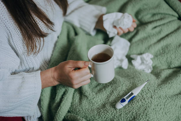 istock Woman sick in bed, covered with blanket 1212179932