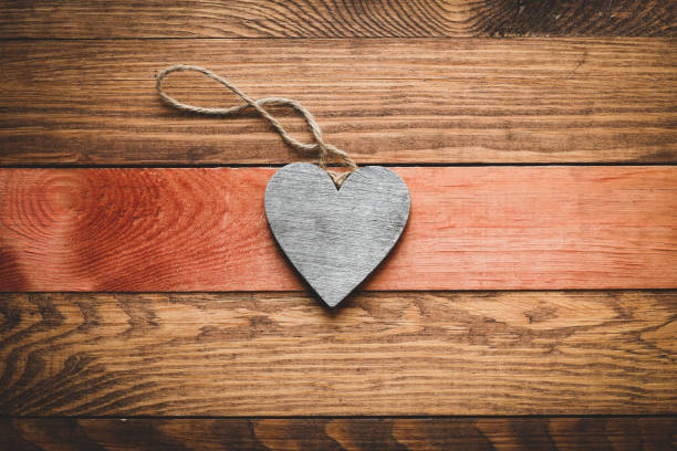 istock Gray heart on a wooden background. 1212180933