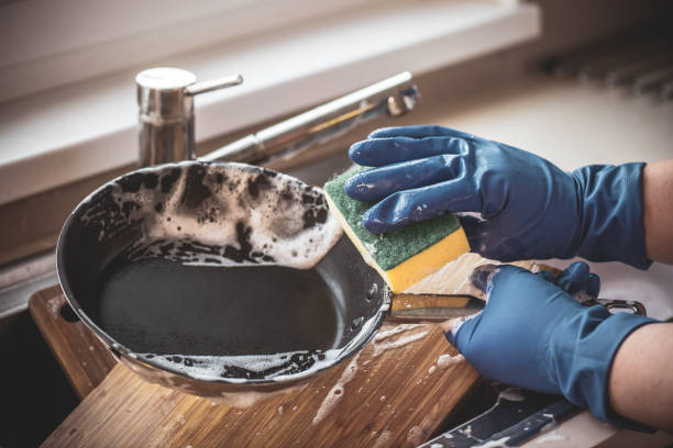 Female hands in gloves wash dishes with detergents Female hands in gloves wash dishes with detergents cleaning sponge stock pictures, royalty-free photos & images