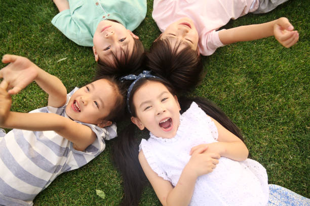 istock The happy children were playing on the grass 1212180988