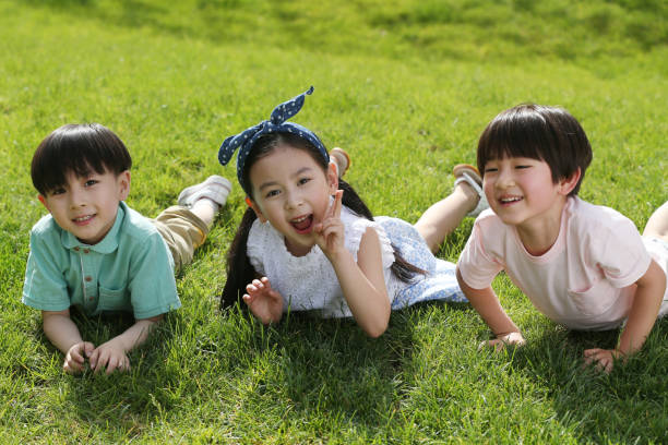 istock The happy children were playing on the grass 1212181009