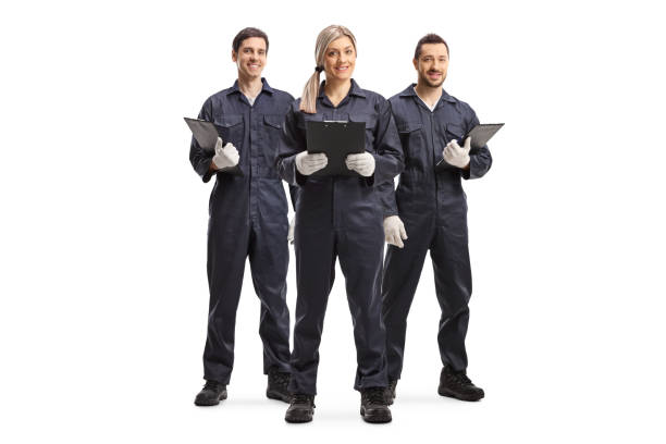One female and two male workers in overall uniforms