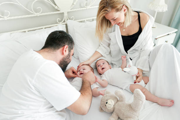 istock Playing Parents And Twin Babies in Bedroom 1212181171