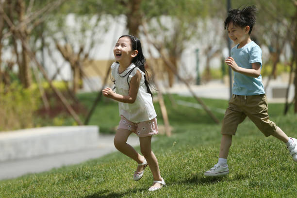 istock Children are playing on the grass 1212181306