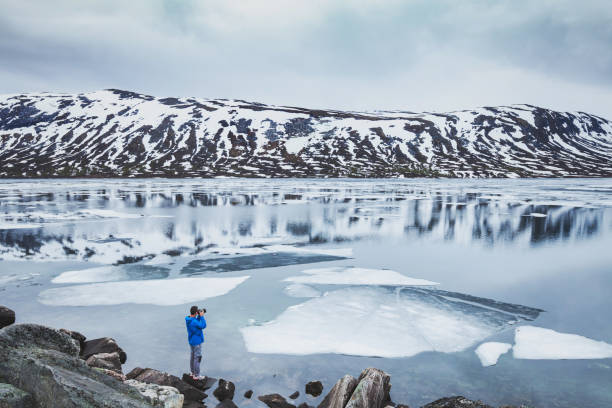 istock tourist taking photo in Norway 1212182150