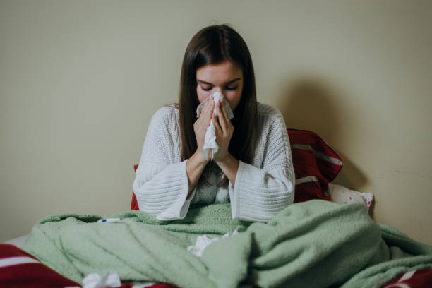 istock Woman sick in bed, covered with blanket 1212182152