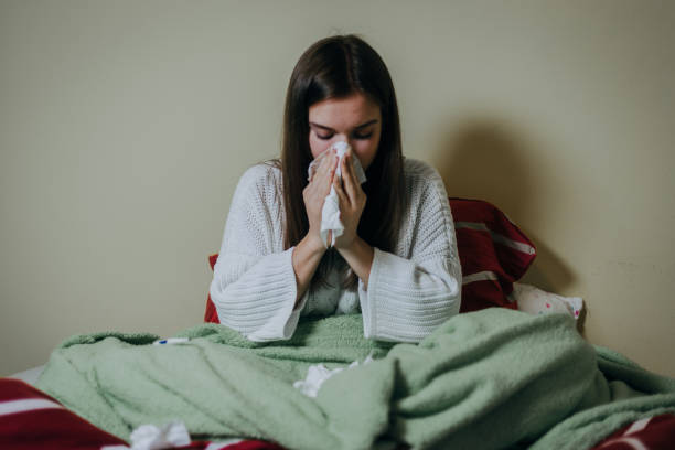 istock Woman sick in bed, covered with blanket 1212182249