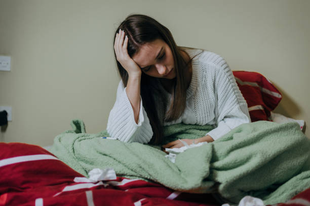 istock Woman sick in bed, covered with blanket 1212182393