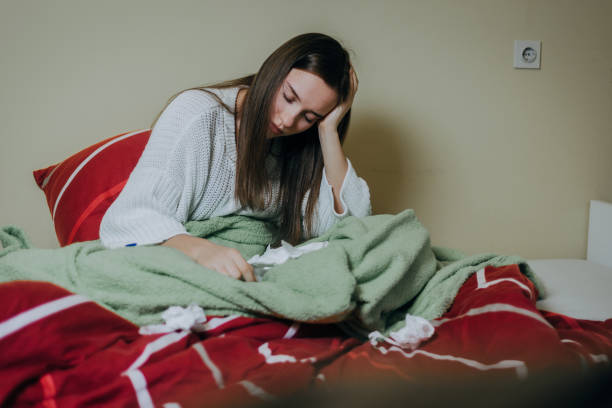 istock Woman sick in bed, covered with blanket 1212182728