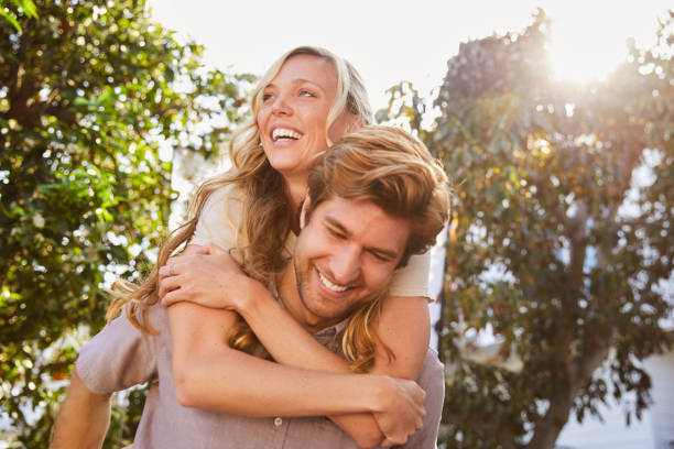 istock Laughing young couple having a fun afternoon together outside 1212185358